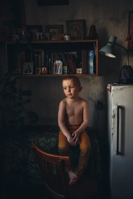 Category winner, open competition, portraiture. Son, featuring a young child sitting on a table while gazing into space, lost in contemplation. The photograph shows another side to childhood, one of calmness and reflection. (Photo by Lyudmila Sabanina/Sony World Photography Awards)