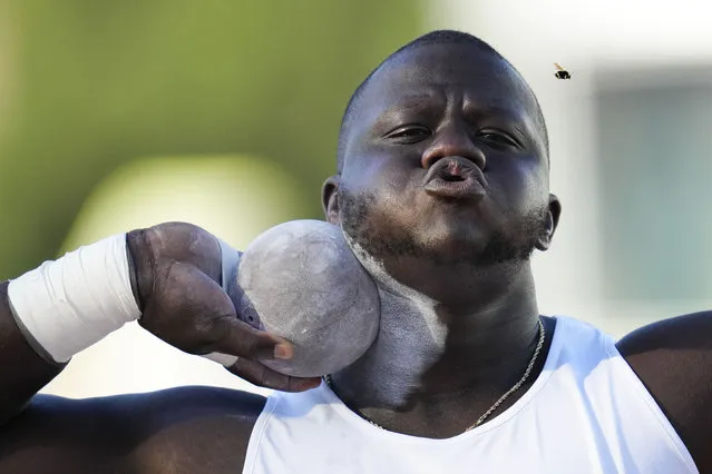 Josh Awotunde blows away a bug as he competes in the men's shot put during the U.S. track and field championships in Eugene, Ore., Sunday, July 9, 2023. (Photo by Ashley Landis/AP Photo)