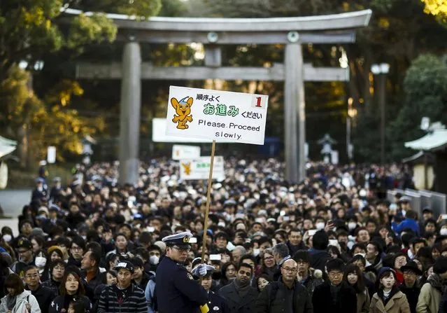 People wait at the gate of the Shinto Meiji Shrine to pray on the first day of the new year in Tokyo, Japan, January 1, 2016. (Photo by Thomas Peter/Reuters)
