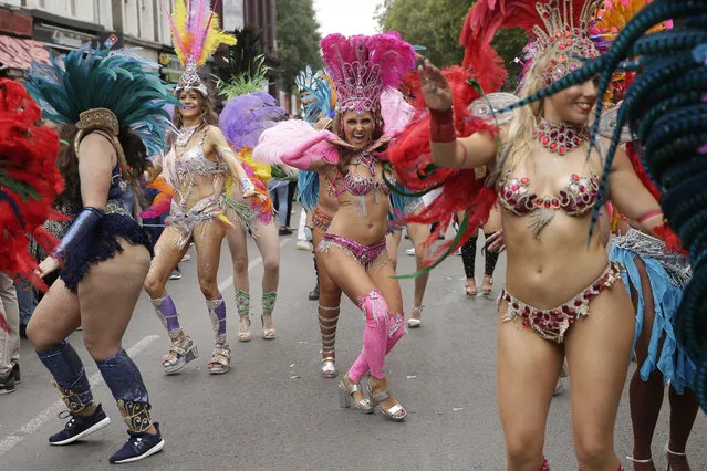 Costumed revellers perform in the parade during the Notting Hill Carnival in London, Monday, August 27, 2018. (Photo by Tim Ireland/AP Photo)