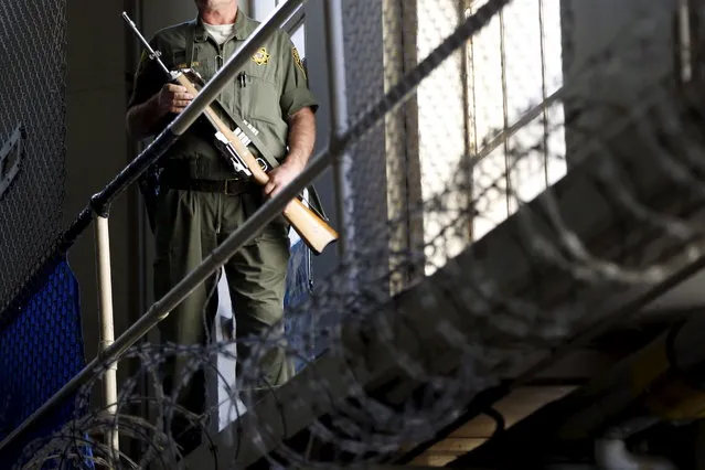 An armed guard patrols on the East Block for condemned prisoners during a media tour of California's Death Row at San Quentin State Prison in San Quentin, California December 29, 2015. (Photo by Stephen Lam/Reuters)