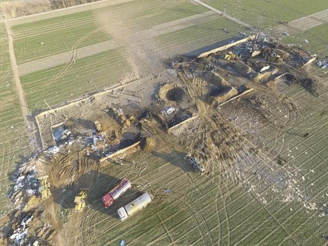 An aerial view shows the debris at an explosion site at a factory making fireworks among corn fields in Xutong County of Kaifeng, Henan province, China, January 14, 2016. At least 10 people were killed and seven others injured by an explosion at an illegal fireworks plant in Henan province on Thursday, Xinhua News Agency reported. (Photo by Reuters/Stringer)