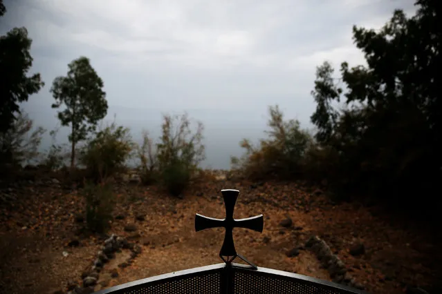 A cross is seen on a gate at Monastery of the Holy Apostles, located on the shore of the Sea of Galilee, northern Israel November 30, 2016. About 1 million tourists from abroad visit the Sea of Galilee, also known as Lake Tiberias or Kinneret, each year, according to the Israeli Tourism Ministry. The gospels tell of Jesus walking on the lake to comfort and save disciples as their ship was foundering in a storm and miraculously producing huge catches for their nets. But the Sea of Galilee may need a few more miracles these days. A sharp drop in annual rainfall in the northern Galilee region over the past three years has caused the lake's waters to recede, according to Israel's Water Authority. It is now at its lowest in five years. This has created problems for the largest freshwater lake in Israel, which is a water resource for the country's north and neighbouring Jordan, a tourist hot-spot and a main fishing zone. (Photo by Ronen Zvulun/Reuters)