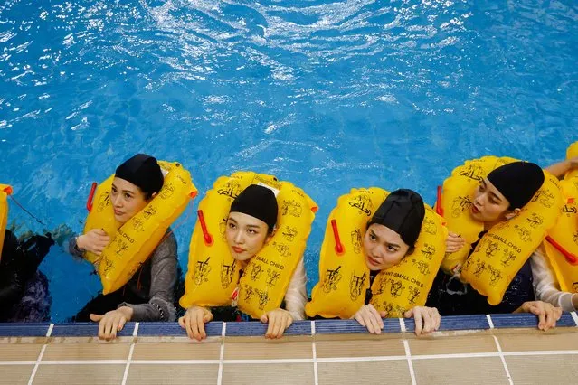 Starlux flight attendants receive emergcy landing and slide trainings in a pool at their center in Taoyuan, Taiwan on April 12, 2023. (Photo by Ann Wang/Reuters)