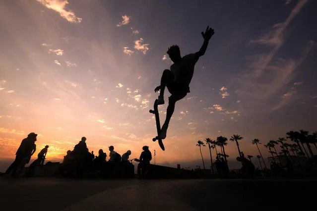 A skateboarder is silhouetted as he jumps high at the skateboard park during sunset on Wednesday, June 16, 2021, in the Venice Beach section of Los Angeles. An unusually early and long-lasting heat wave brought more triple-digit temperatures Wednesday to a large swath of the U.S. West, raising concerns that such extreme weather could become the new normal amid a decades-long drought. (Photo by Ringo H.W. Chiu/AP Photo)