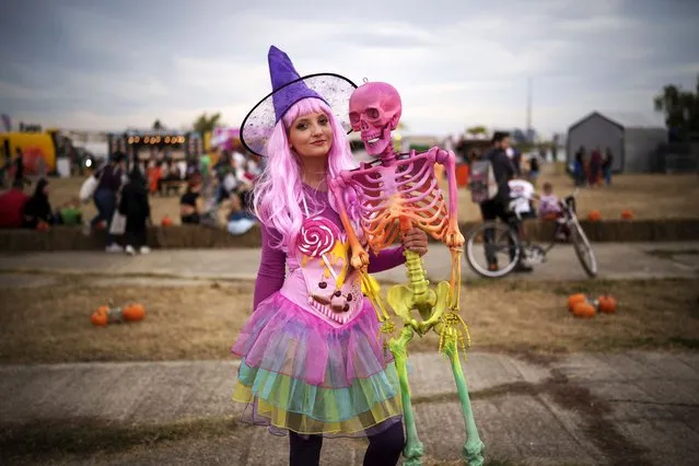 A woman poses for a photograph at the West Side Hallo Fest, a Halloween festival in Bucharest, Romania, Friday, October 27, 2023. Tens of thousands streamed last weekend to Bucharest's Angels' Island peninsula for what was the biggest Halloween festival in the Eastern European nation since the fall of Communism. (Photo by Vadim Ghirda/AP Photo)