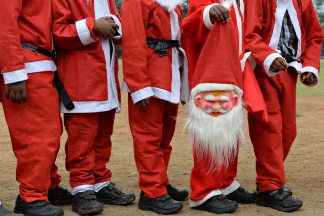 Indian schoolchildren dressed as Santa Claus pose as they take part in a Christmas event at a school in Chennai on December 5, 2018. (Photo by Arun Sankar/AFP Photo)