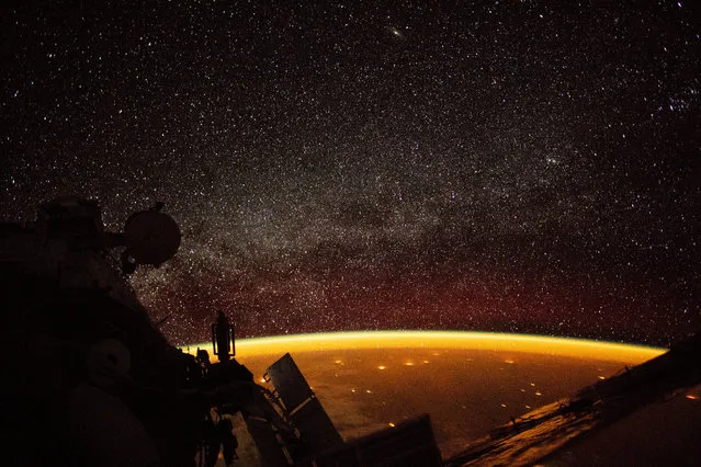 An orange hue envelops the Earth, known as “airglow”, a phenomenon that occurs when ultraviolet radiation hits molecules in the atmosphere and creates a band of light that reaches 50 to 400 miles high, in this image taken on board the International Space Station (ISS), October 7, 2018. (Photo by NASA/Handout via Reuters)