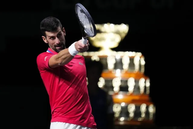 Serbia's Novak Djokovic reacts, with the Davis Cup on the background, during a Davis Cup quarter-final tennis match against Britain's Cameron Norrie in Malaga, Spain, Thursday, November 23, 2023. (Photo by Manu Fernandez/AP Photo)