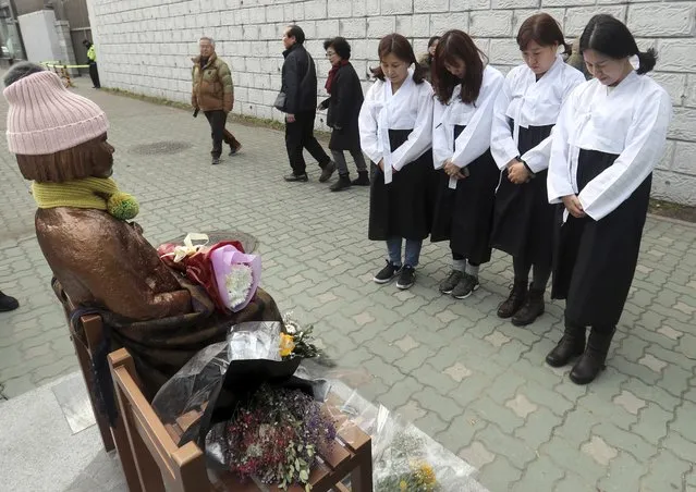 South Korean women wearing traditional dress pay theirs respects to a “comfort-woman” statue set up in front of the Japanese consulate in Busan, South Korea, Friday, January 6, 2017. Japan announced Friday that it would recall its ambassador to South Korea and suspend economic talks in response to the placing of a “comfort-woman” statue representing wartime s*x slaves in front of its consulate in the Korean port city of Busan. (Photo by Kim Sun-ho/Yonhap via AP Photo)