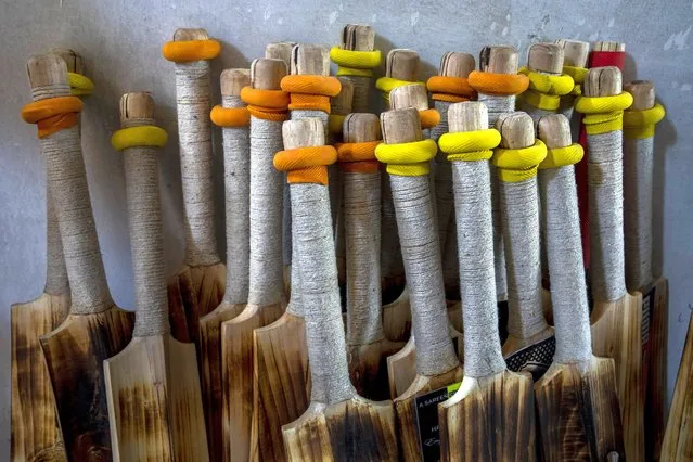 Finished cricket bats are seen inside a factory in Sangam, south of Srinagar, Indian controlled Kashmir, September 22, 2022. Kashmir’s dwindling willow plantations are impacting the region’s famed cricket bat industry and risking the supply of cricket bats in India, where the sport is hugely followed. The industry employs more than 10,000 people and manufactures nearly a million bats a year. (Photo by Dar Yasin/AP Photo)