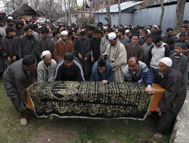 Kashmiris carry a coffin containing the body of Mushatq Ahmad Wani, an Indian policeman, for his funeral prayers in Arigam, south of Srinagar April 6, 2015. Three policemen including Wani were killed on Monday in south Kashmir after suspected separatist militants opened fire on them while they were travelling in a private vehicle, police said. (Photo by Danish Ismail/Reuters)