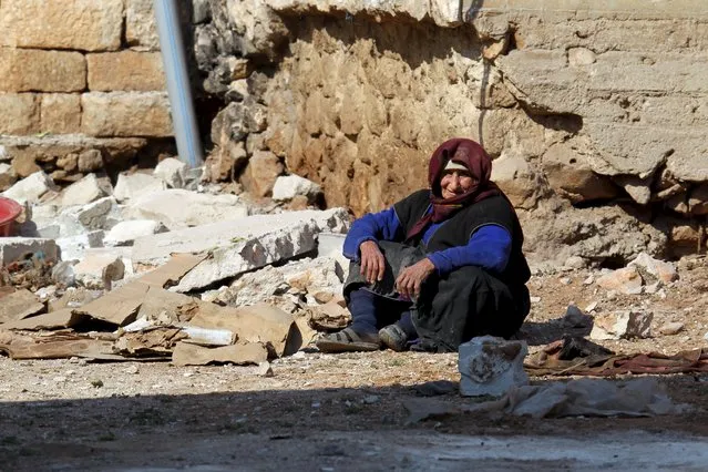 A women rests near rubble on the ground in the town of Darat Izza, province of Aleppo, Syria February 28, 2016. (Photo by Ammar Abdullah/Reuters)