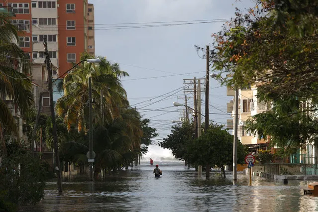 People make their way on a flooded street in Havana, Cuba, January 23, 2017. (Photo by Alexandre Meneghini/Reuters)