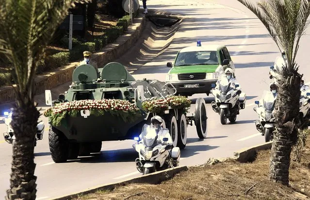 The convoy carrying the coffin of former Algerian President Abdelaziz Bouteflika drives on its way to the El Alia cemetery in Algiers, Sunday, September 19, 202. Algeria's leader declared a three-day period of mourning starting Saturday for former President Abdelaziz Bouteflika, whose 20-year-long rule, riddled with corruption, ended in disgrace as he was pushed from power amid huge street protests when he decided to seek a new term. Bouteflika, who had been ailing since a stroke in 2013, died Friday at 84. (Photo by Fateh Guidoum/AP Photo)