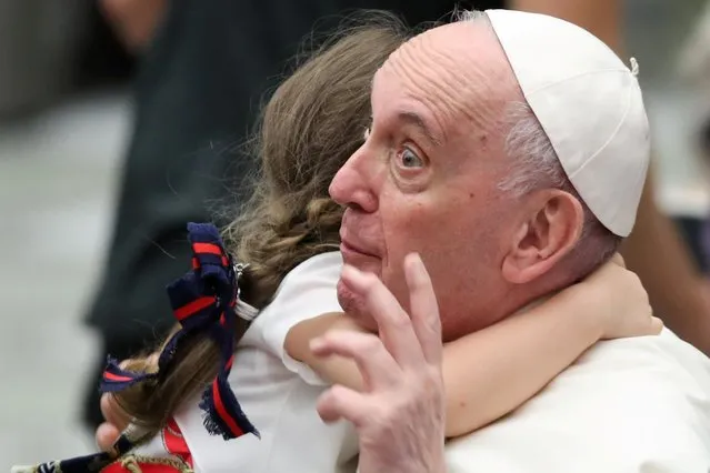 A child hugs Pope Francis during the weekly general audience at the Paul VI Audience Hall, at the Vatican, September 22, 2021. (Photo by Yara Nardi/Reuters)