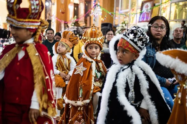 A kid dressed as one of the Three Wise Men gestures during the traditional “Three Wise Men Parade” on January 6, in Miahuatlan, Mexico. Every year the residents of the Miahuatlan municipality organize a parade where kids get down the streets dressed as “Melchor, Gaspar and Baltazar”, which are the names given to the wise men in some regions of Latin America. (Photo by Hector Quintanar/Getty Images)