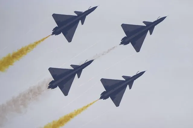 Members of the “August 1st” Aerobatic Team of the Chinese People's Liberation Army (PLA) Air Force perform during the 13th China International Aviation and Aerospace Exhibition, also known as Airshow China 2021, on Tuesday, September 28, 2021, in Zhuhai in southern China's Guangdong province. (Photo by Ng Han Guan/AP Photo)