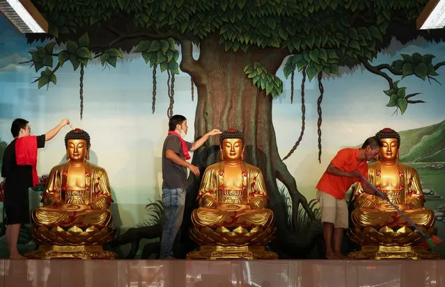 Worshipers clean Buddha statues ahead of the Chinese Lunar New Year celebration at the Amurva Bhumi temple in Jakarta, Indonesia, on February 2, 2024. (Photo by Ajeng Dinar Ulfiana/Reuters)