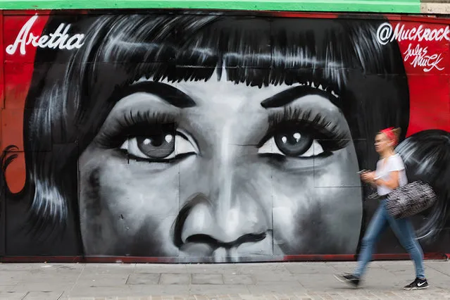 A woman walks past new street art in Shoreditch, east London, UK on August 19, 2018, paying tribute to the singer, Aretha Franklin who has died following a battle with pancreatic cancer. The mural has been created by artist, Jules Muck in collaboration with Global Street Art. (Photo by Vickie Flores/LNP)
