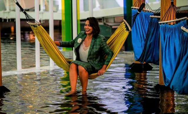 Brazilian President Jair Bolsonaro's wife Michelle sits in the water pool of the Brazilian Pavilion on the occasion of the Brazilian National Day during the EXPO 2020 Dubai in Dubai, United Arab Emirates, 15 November 2021. Some 192 countries take part in the EXPO 2020 Dubai which runs from 01 October 2021 to 31 March 2022. (Photo by Ali Haider/EPA/EFE)