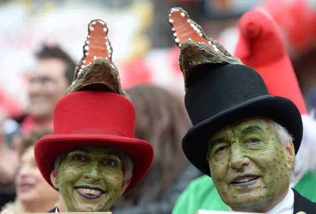 Costumed carnival goers walk during the traditional Rose Monday parade in Duesseldorf, western Germany on March 3, 2014. Carnival goers mainly in the Rhine region traditionally celebrate the highlight procession on Rosenmontag (Rose Monday). (Photo by Patrik Stollarz/AFP Photo)