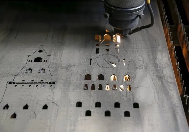 A worker produces parts for barbecue grills in the shape of Moscow's Kremlin at a plant in Kiev May 14, 2015. (Photo by Gleb Garanich/Reuters)
