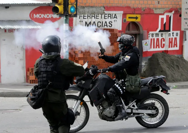 Riot policemen launch tears gas canisters during clashes with coca growers from Yungas in La Paz, Bolivia February 21, 2017. (Photo by David Mercado/Reuters)