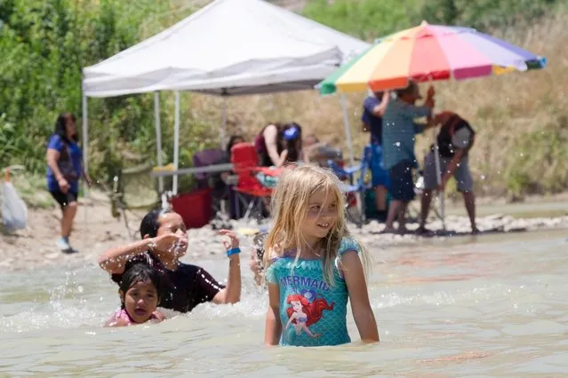 Kids from both Mexico and the United States play together at the Voices From Both Sides festival which is held on the banks of the Rio Grande, an international boundary, to celebrate their cross-border community on both sides of the U.S.-Mexico in Lajitas, Texas, May 11, 2019. (Photo by Jessica Lutz/Reuters)