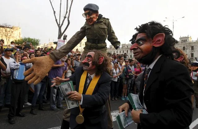Protesters representing corruption perform during a march against Peruvian presidential candidate Keiko Fujimori in downtown Lima, Peru, April 5, 2016. (Photo by Guadalupe Pardo/Reuters)
