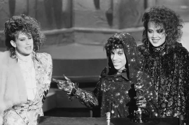 Prince and members of his group accept their Oscar for Best Original Song Score for “Purple Rain” in Los Angeles, CA on March 25, 1985. (Photo by Bettmann/Getty Images)