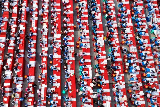 Aerial view of primary and secondary school students attending a painting and calligraphy competition on March 30, 2024 in Qiandongnan Miao and Dong Autonomous Prefecture, Guizhou Province of China. Over 1,000 students took part in the competition on March 30. (Photo by Yang Jian/VCG via Getty Images)