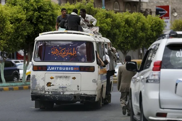 People ride atop a crowded bus in Yemen's capital Sanaa May 6, 2015. Acute fuel shortages have brought most of the public transportation means in Yemen to a standstill. (Photo by Khaled Abdullah/Reuters)