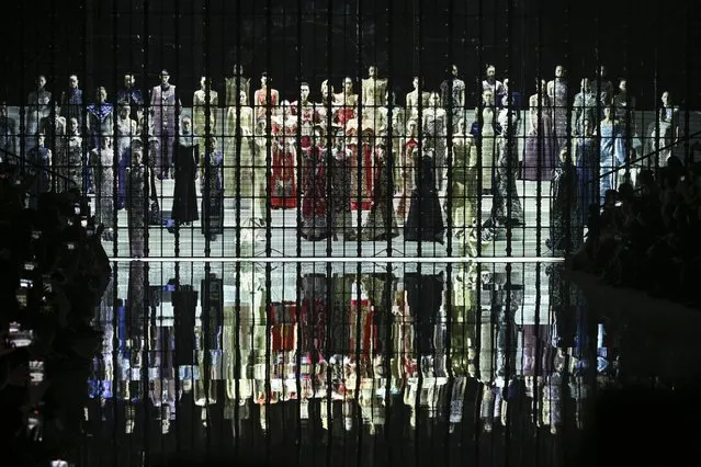 Models stand behind a screen as they display a creation from the Loolayy collection by Zhang Xiaoqi during the China Fashion week in Beijing on March 23, 2024. (Photo by Wang Zhao/AFP Photo)