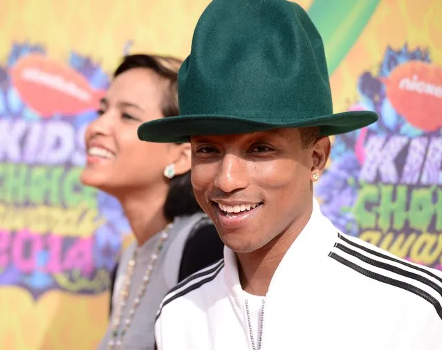 Pharrell Williams, right, and Helen Lasichanh arrive at the 27th annual Kids' Choice Awards at the Galen Center on Saturday, March 29, 2014, in Los Angeles. (Photo by Dan Steinberg/Invision/AP Photo)