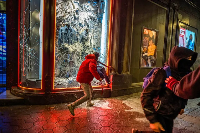 Protestors break the window of the Diesel store on Passeig de Gràcia in Barcelona, Spain on February 20, 2021 during the demonstration in response to the arrest and imprisonment of rapper Pablo Hasél who is accused of exalting terrorism and insulting the crown with the content of the lyrics of his songs. (Photo by Paco Freire/SOPA Images/Rex Features/Shutterstock)