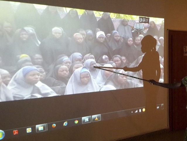 A student who escaped when Boko Haram rebels stormed a school and abducted schoolgirls, identifies her schoolmates from a video released by the Islamist rebel group at the Government House in Maiduguri, Borno State May 15, 2014. Boko Haram, a nickname which translates roughly as “Western education is sinful”, formed around a decade ago as a clerical movement opposed to Western influence. (Photo by Reuters/Stringer)