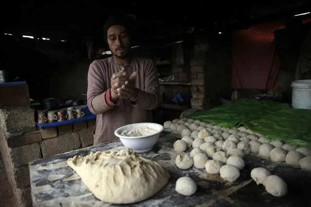 A man bakes local bread at a bakery in Islamabad, Pakistan, Wednesday, January 5, 2022. (Photo by Rahmat Gul/AP Photo)