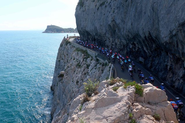 The pack rides at Noli's cape during the 4th stage of the 107th Giro d'Italia cycling race, 190 km between Acqui Terme and Andora, on May 7, 2024 in Noli. (Photo by Luca Bettini/AFP Photo)