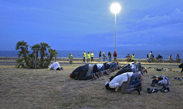 Migrants kneel in prayer, in Ventimiglia, at the Italian-French border Tuesday, June 16, 2015. Police at Italy's Mediterranean border with France forcibly removed a few dozen African migrants who have been camping out for days in hopes of continuing their journeys farther north, a violent scene Italy is using to show that Europe needs to do something about the migrant crisis. (AP Photo/Lionel Cironneau)