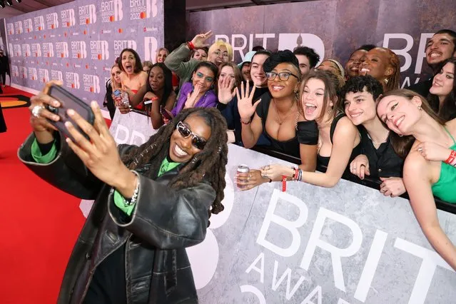 British rapper Little Simz takes a selfie with fans at The BRIT Awards 2022 at The O2 Arena on February 08, 2022 in London, England. (Photo by JMEnternational/Getty Images)