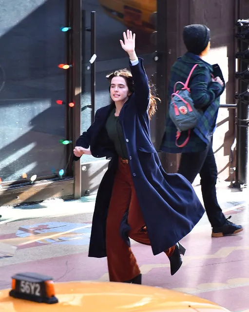 American actress Zoey Deutch is spotted filming an untitled project in downtown Los Angeles on February 3, 2022. The 27 year old actress chased a yellow taxi while wearing a blue trench coat, green top, rust corduroy trousers, and black heels. (Photo by The Image Direct)