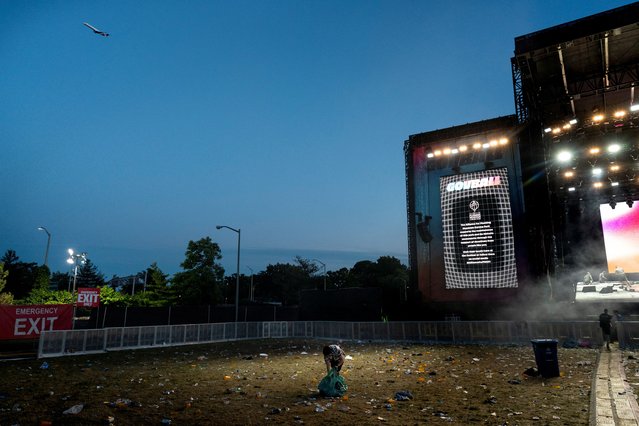 A worker cleans up garbage following a performance at the Governors Ball music festival at Corona Park in the Queens borough of New York City, U.S., June 9, 2024. (Photo by Cheney Orr/Reuters)
