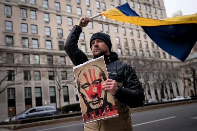 Supporters of Ukrainian sovereignty protest the Russian invasion of Ukraine, Thursday, February 24, 2022, in New York. World leaders Thursday condemned Russia's invasion of Ukraine as “barbaric” and moved to slap unprecedented economic sanctions on Moscow and those close to President Vladimir Putin. (Photo by John Minchillo/AP Photo)