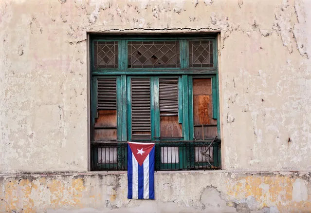 A Cuban flag hangs on a building in Havana, Cuba April 30, 2016. (Photo by Enrique de la Osa/Reuters)