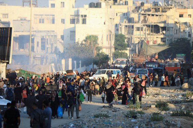 Palestinians, who fled the eastern part of Gaza City after they were ordered by Israeli army to evacuate their neighborhoods, carry their belongings, amid Israel-Hamas conflict, in Gaza City, on July 7, 2024. (Photo by Dawoud Abu Alkas/Reuters)