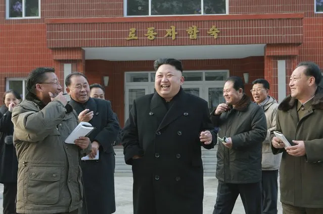 North Korean leader Kim Jong Un (C) laughs during his visit to the Kangdong Precision Machine Plant in this undated photo released by North Korea's Korean Central News Agency (KCNA) in Pyongyang January 16, 2015. (Photo by Reuters/KCNA)