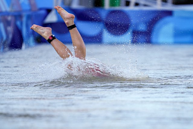 Switzerland's Julie Derron dives into the water for the start of the mixed relay triathlon at the 2024 Summer Olympics, Monday, August 5, 2024, in Paris, France. (Photo by Vadim Ghirda/AP Photo)