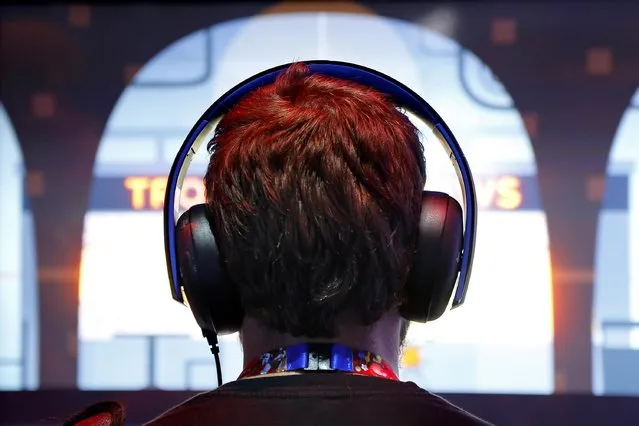 A gamer wears headphones while playing a game at the 2014 Electronic Entertainment Expo, known as E3, in Los Angeles, June 10, 2014.  REUTERS/Jonathan Alcorn