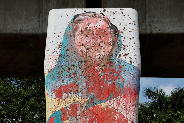 A mural of Bangladeshi Ex Prime Minister Sheikh Hasina is seen vandalised by protesters days before in Dhaka, Bangladesh, on August 5, 2024. (Photo by Mohammad Ponir Hossain/Reuters)